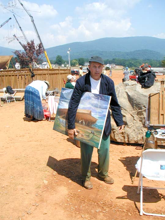 It was a strange experience painting by the seat of my pants (Speaking of pants, that's my "flood wardrobe" I'm wearing) and working in front of an audience of over a thousand crew, actors and extras, but exhilarating for me as well, since they all had nice things to say as they saw the painting develop during the shoot. In the distance, you can see the huge water sprayers called "rain crosses" hoisted up over a hundred feet in the air by cranes. In this photo I've been freshly soaked along with hundreds of extras so that we looked convincingly inundated by a cloudburst.